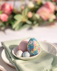 Painted Easter eggs on a green table napkin
