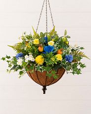 Yellow and blue artificial flowers in a hanging basket