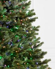 Close-up image of an artificial Christmas tree with multicolored lights.