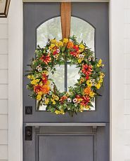 Flower wreath with ribbon on door