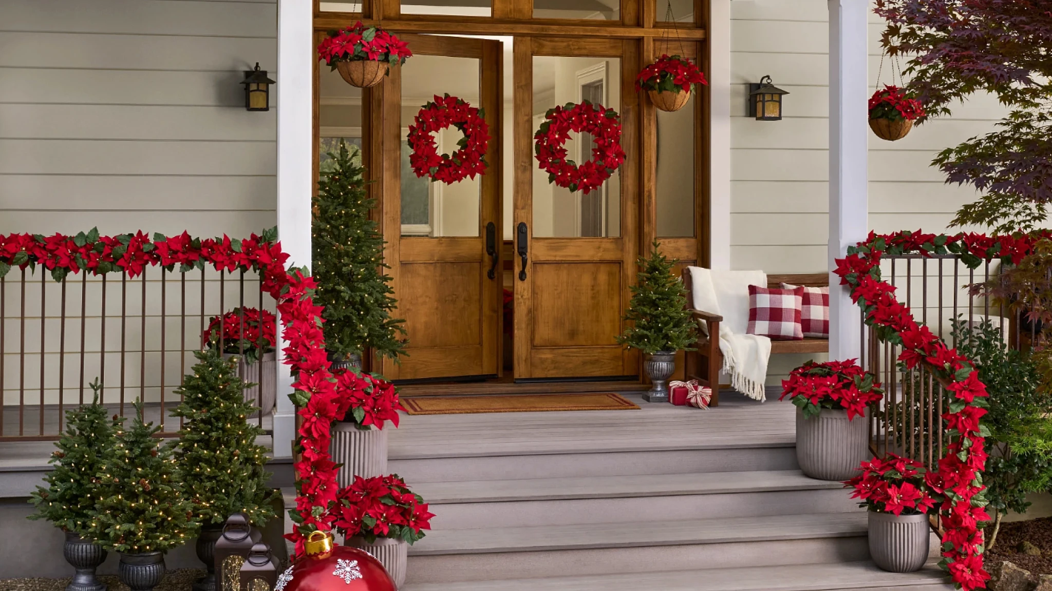 Porch decorated with red poinsettia foliage
