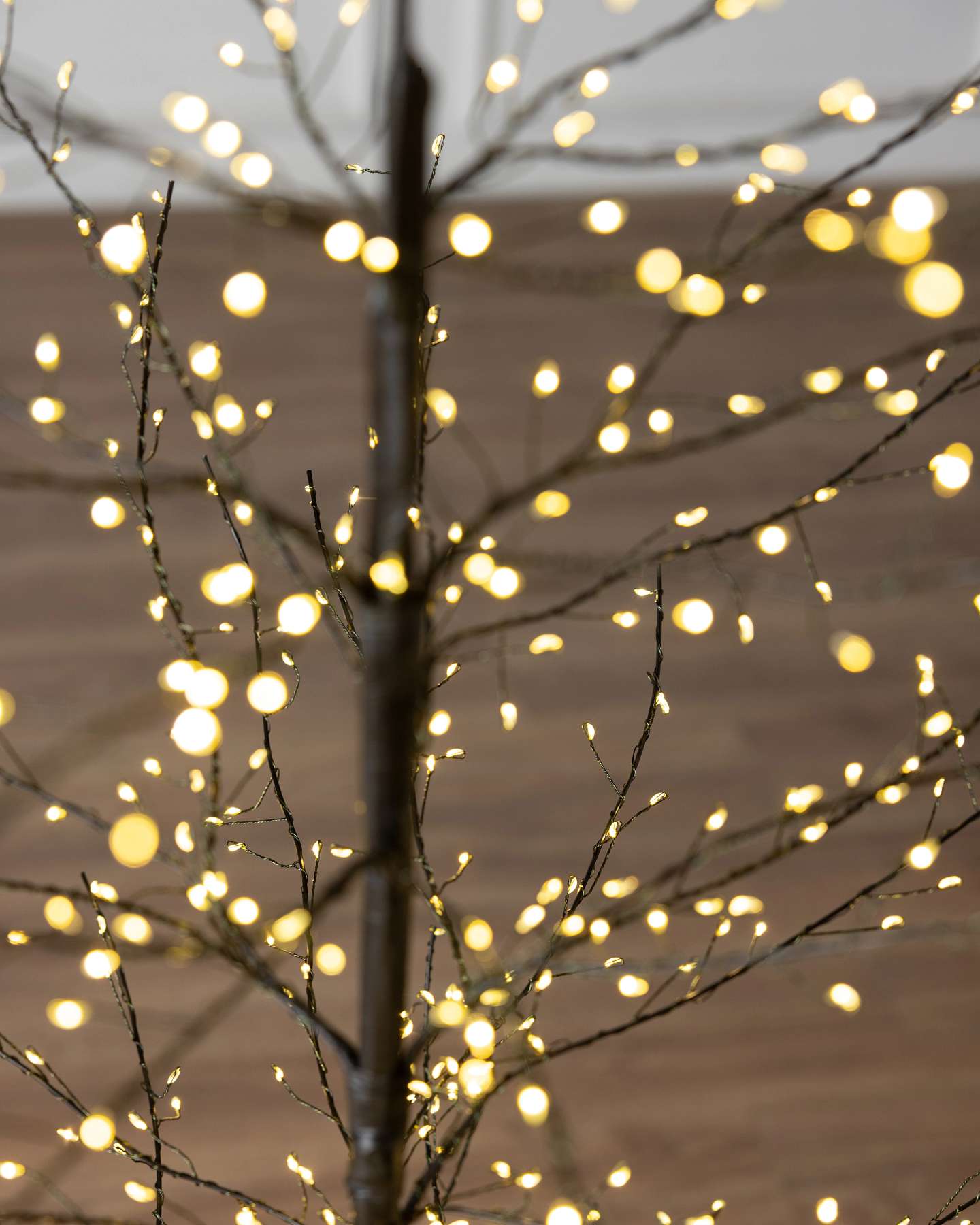 Balsam Hill 5-Foot Black Outdoor Fairy Light Twig Artificial Christmas Tree Branch and Lights Closeup