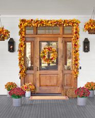 Front porch décor idea with autumn wreaths, garlands, and urn fillers