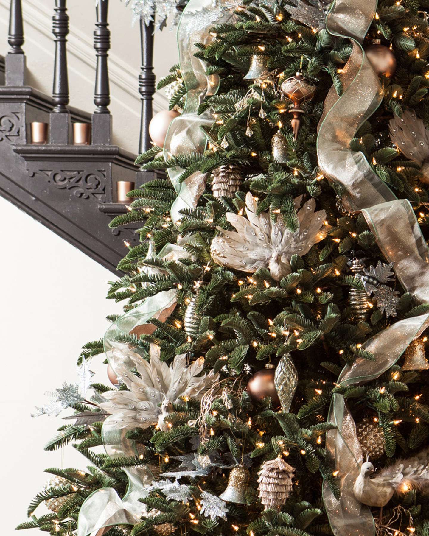 Balsam Hill Noble Fir Flip Artificial Christmas Tree Lifestyle Display Near Stairs Closeup