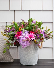 Artificial potted flowers with  lavender, daisies, pomegranates, rose hips, purple hydrangeas, and pink gerberas