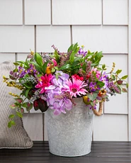 Artificial potted flowers with lavender, daisies, pomegranates, rose hips, purple hydrangeas, and pink gerberas