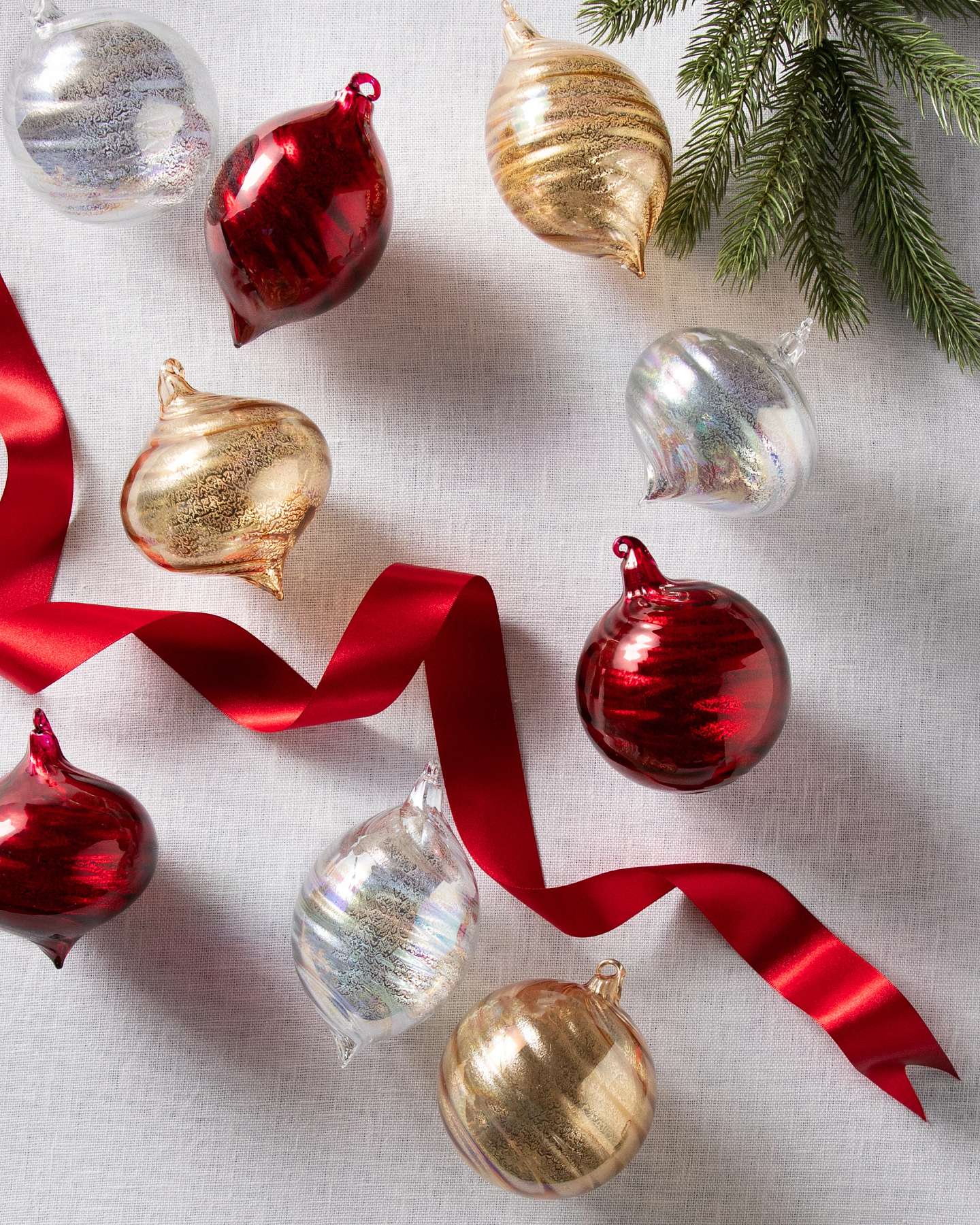 Balsam Hill Essentials Swirl Christmas Ornament Set Lifestyle Display with Silver, Gold, and Red Ornaments