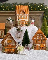Miniature Christmas village on artificial snow with bottle brush trees and felt polar bear and reindeer ornaments