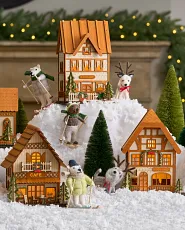 Miniature Christmas village on artificial snow with bottle brush trees and felt polar bear and reindeer baubles