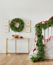 Decorated Christmas wreath and garland in a foyer