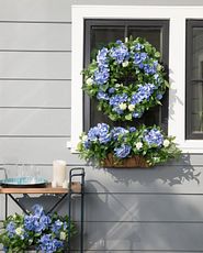 Window decoration with spring wreath, window box, and flower arrangement