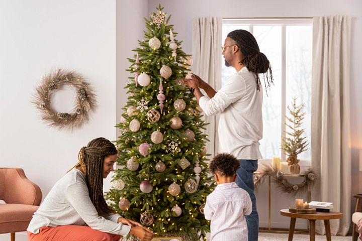 Family decorating a Christmas tree