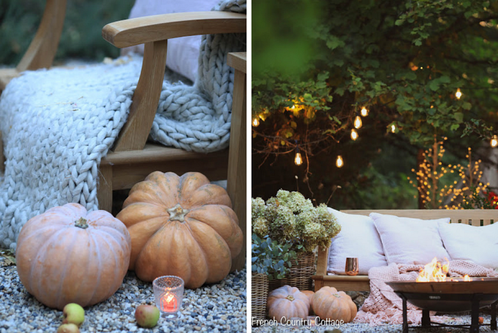 Outdoor seating area decorated with pumpkins, blankets, and lights