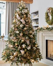 Christmas tree decorated with vintage gold Christmas baubles and ribbon