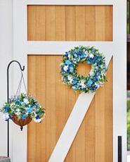 Blue flower wreath and hanging basket on wood door
