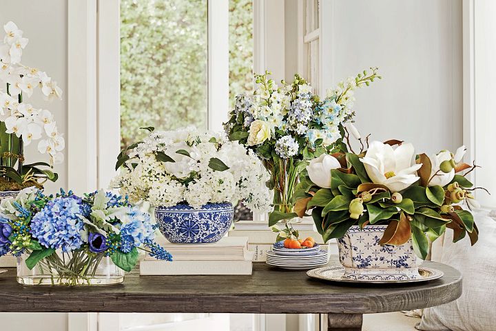 Assorted artificial flower arrangements on wooden table