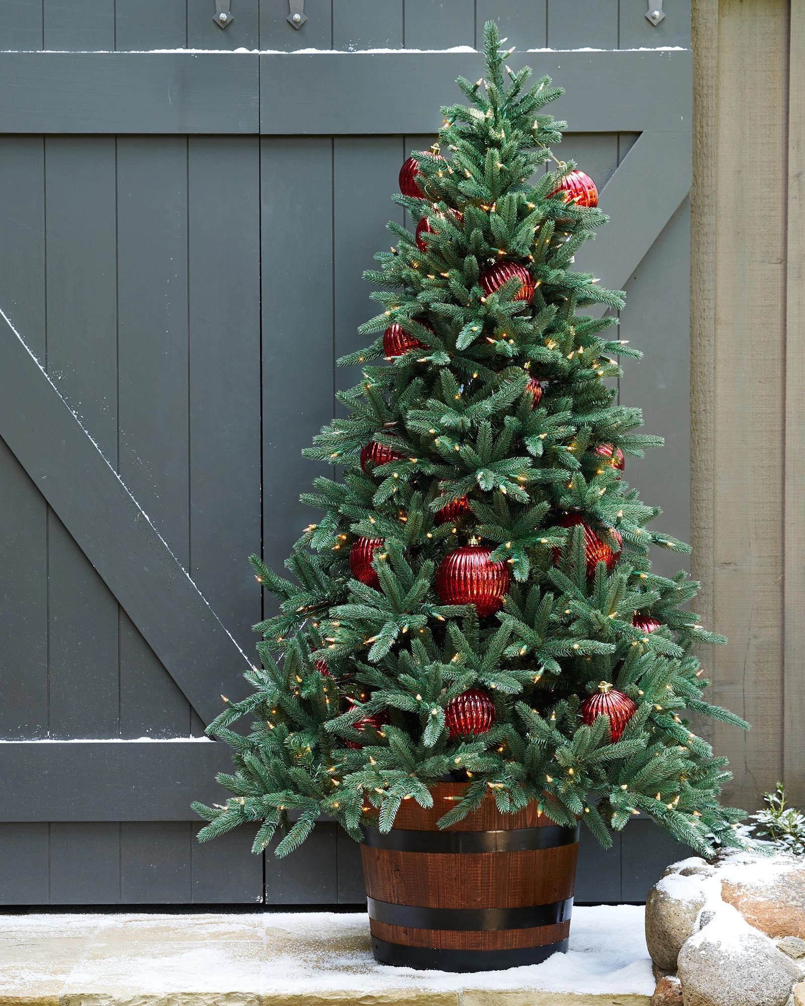 Artificial Christmas tree with ornaments displayed outdoors