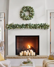 Elegant mantel decorating idea with mixed eucalyptus wreath, garland, and flameless candles