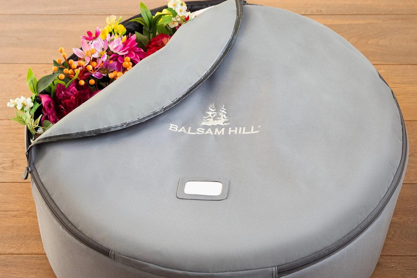 A man stringing lights on a Christmas tree