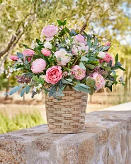 Artificial potted roses in woven basket