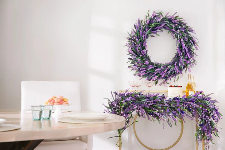A dessert cart decorated with artificial lavender wreath and garland