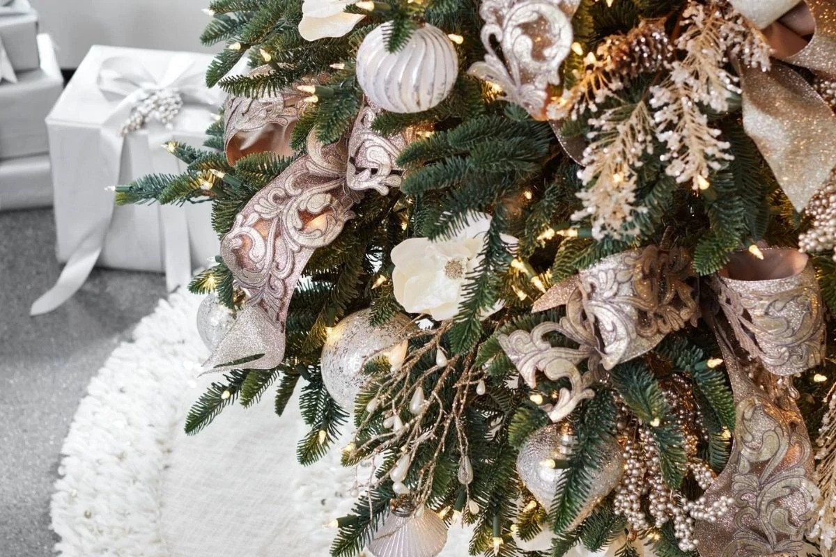 An artificial Christmas tree decorated with ribbons, picks, and sprays