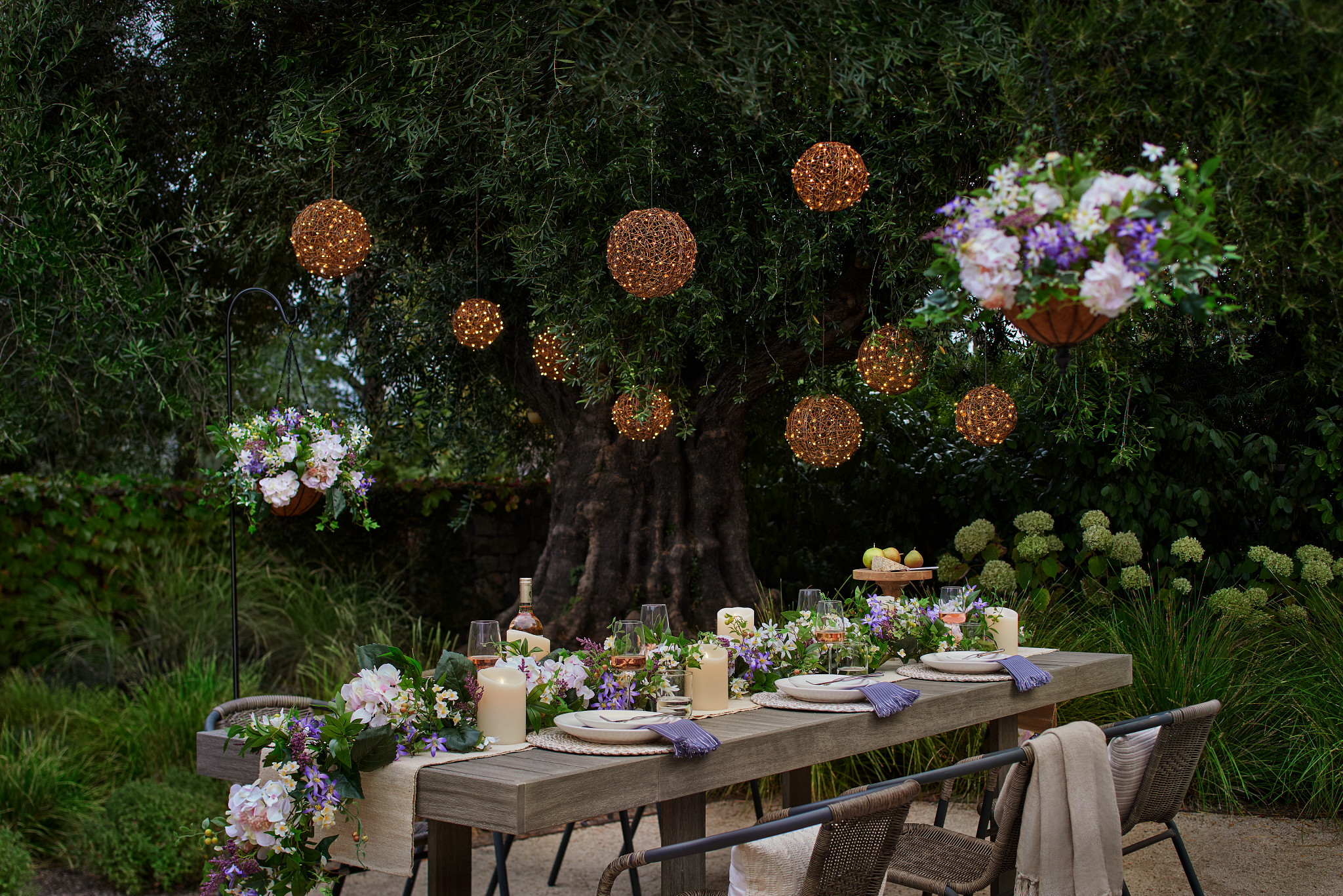 Outdoor dining area decorated with artificial flower garland