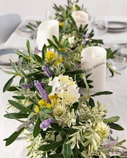 Artificial flower garland with urple cattails, white lilacs, and thistle