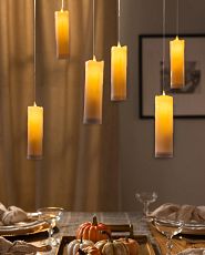 Floating candle décor over a fall-themed dining table