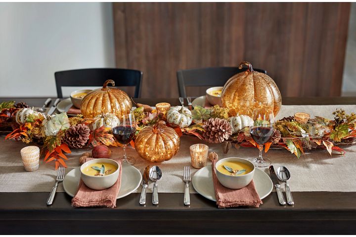 Thanksgiving tablescape with lighted glass pumpkins and fall foliage