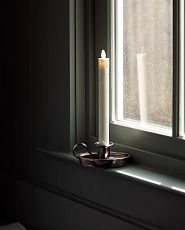 LED chamberstick candle on a window ledge
