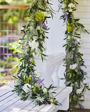 Artificial flower garland with lilacs and thistle