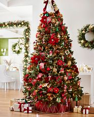  Artificial Christmas tree decorated with red and green ornaments, plaid ribbons, and metallic red tree collar