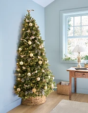 Flatback Christmas tree in a guest room with a blue wall