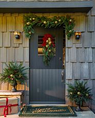 Front door decorated with a Christmas swag