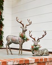 Pair of red oversized ornaments with Merry and Christmas words on each