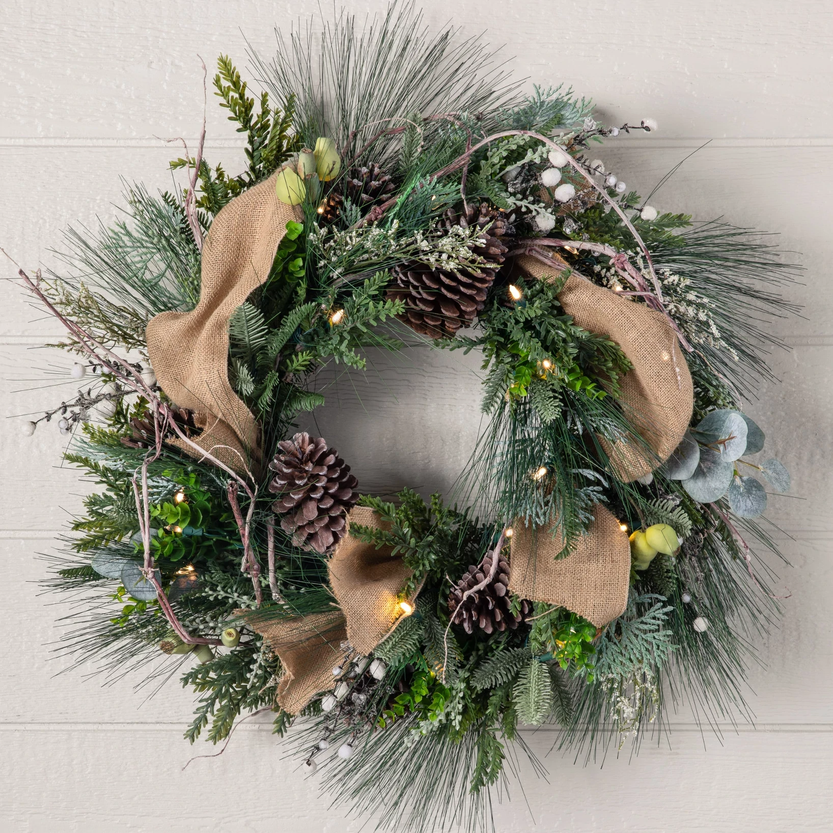 A Christmas wreath with pinecones and ribbon