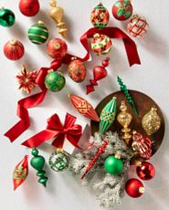 Classic red, green, and gold Christmas ornaments on white background