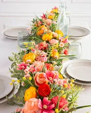 Garland table runner with yellow, pink, and red flowers