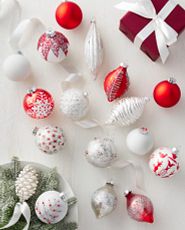 Red and white Nordic Christmas ornaments on white background