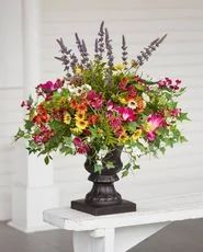Colorful artificial flowers and foliage in a vase