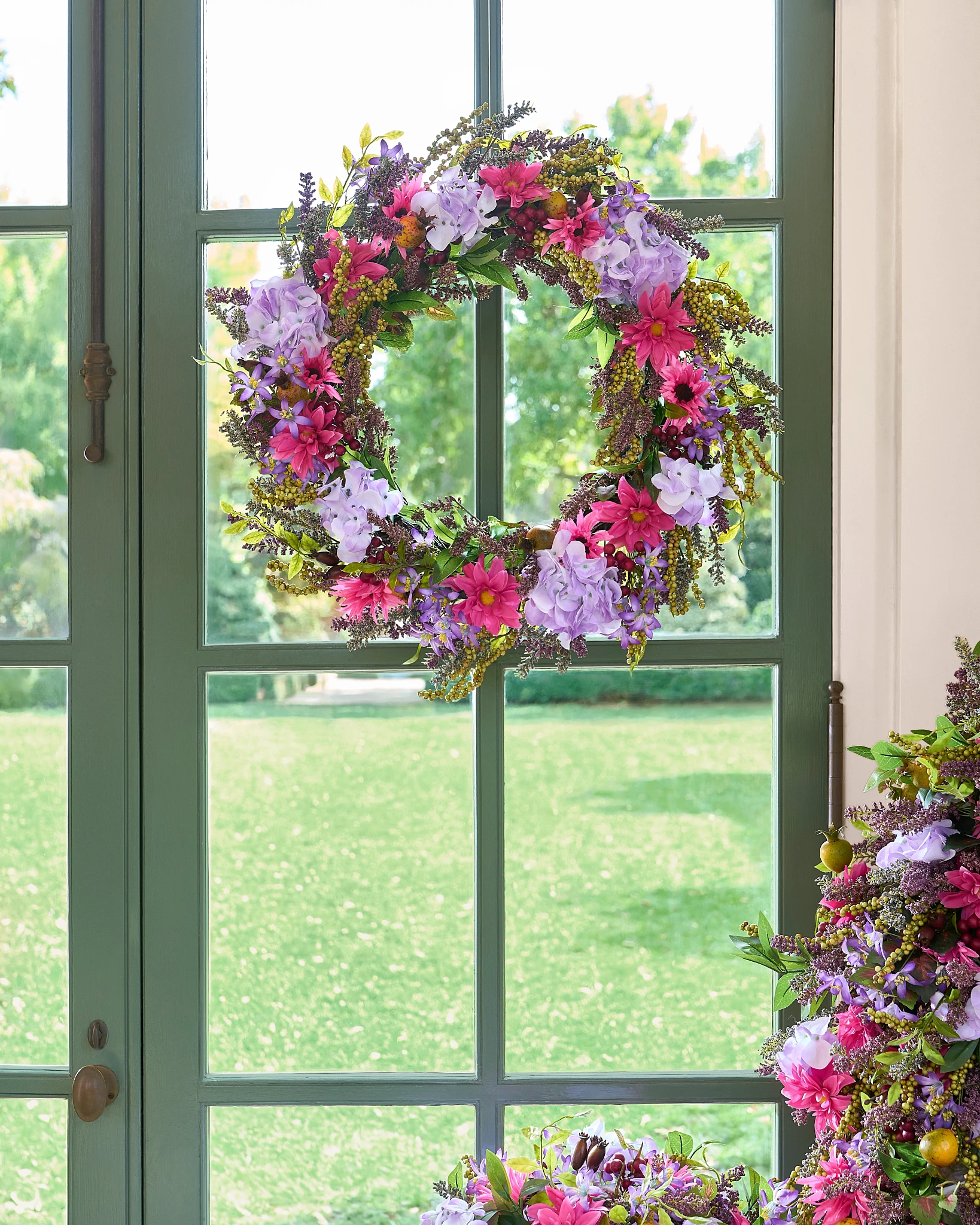 Artificial wreath with lilac and pink flowers
