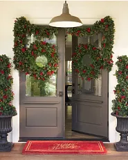 Front door decorated with Christmas greenery