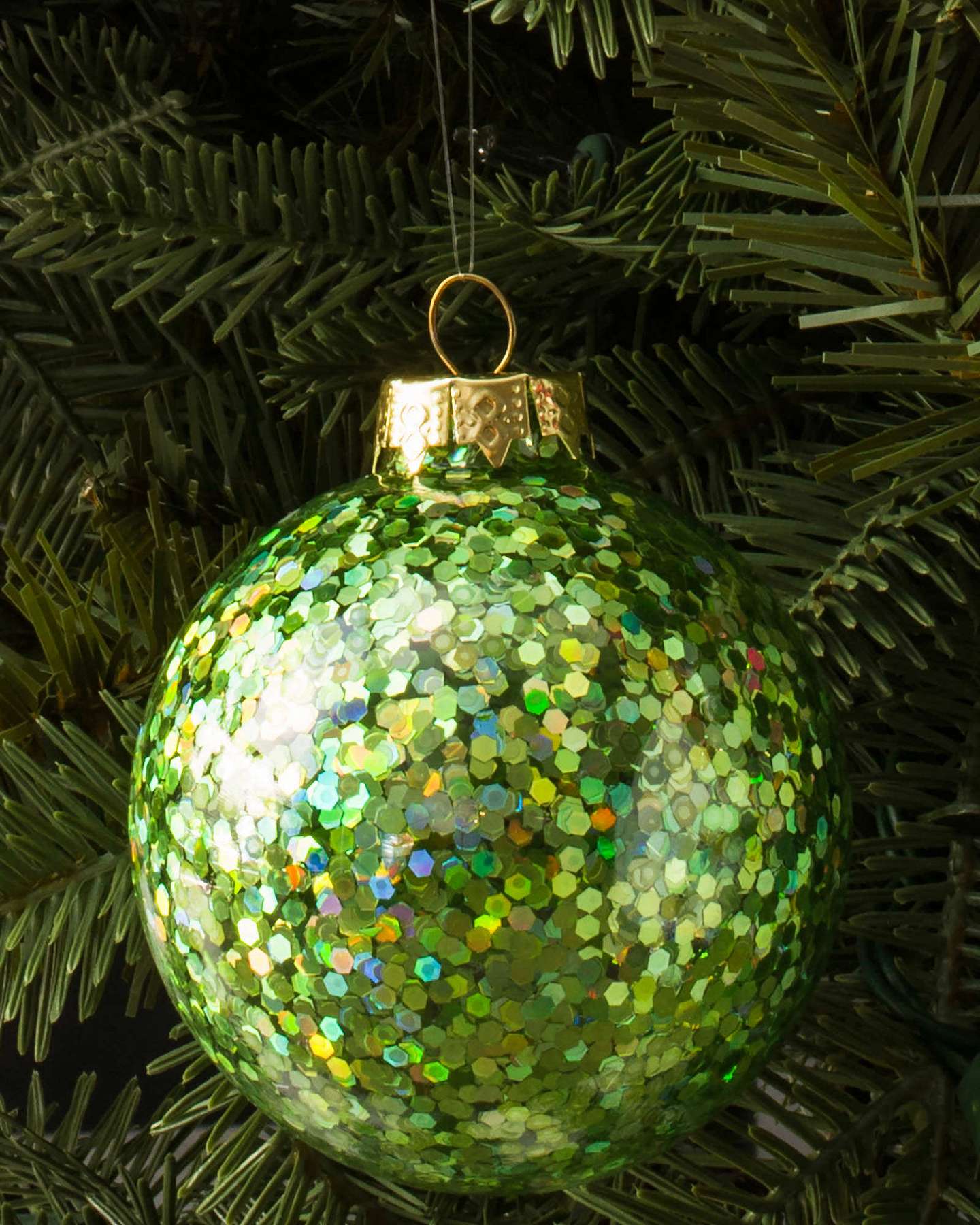 Balsam Hill Mistletoe and Holly Glass Christmas Ornaments Hung on Tree Branches with Red Ribbon