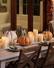 Artificial pumpkins with LED lights on table