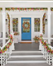 Spring porch décor idea with colorful wreaths and garlands