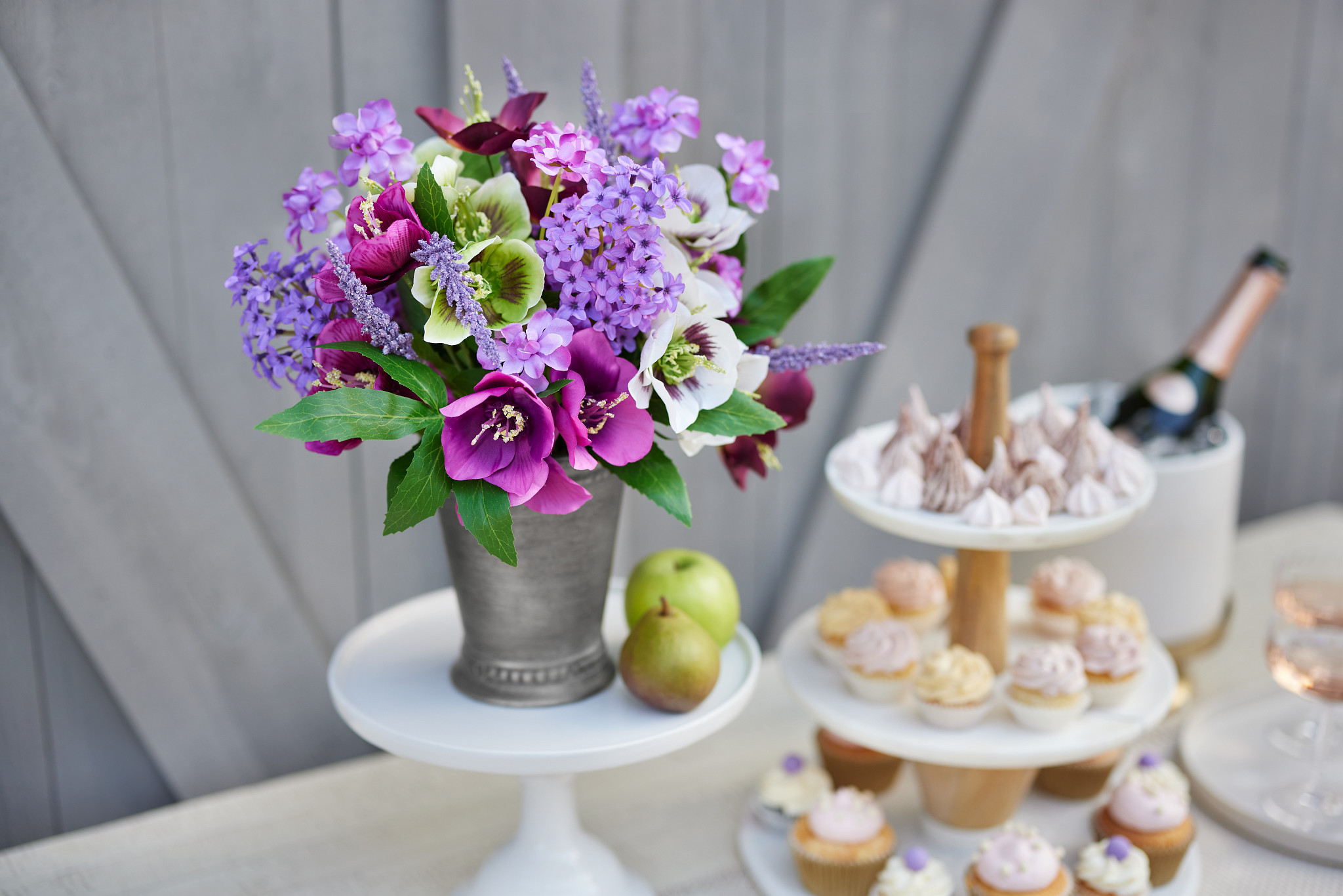 Artificial flower arrangement with purple hellebores