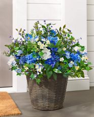 Artificial flower arrangement in a wicker basket