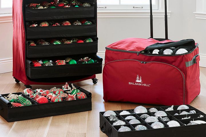 Balsam Hill red storage bags with assorted ornaments in trays