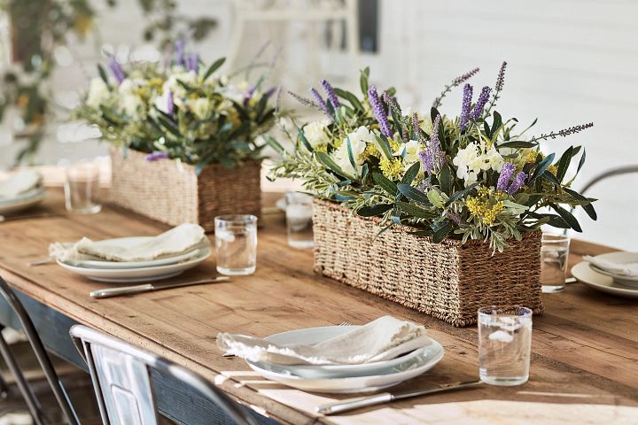 Dining table decorated with artificial spring arrangement and place settings